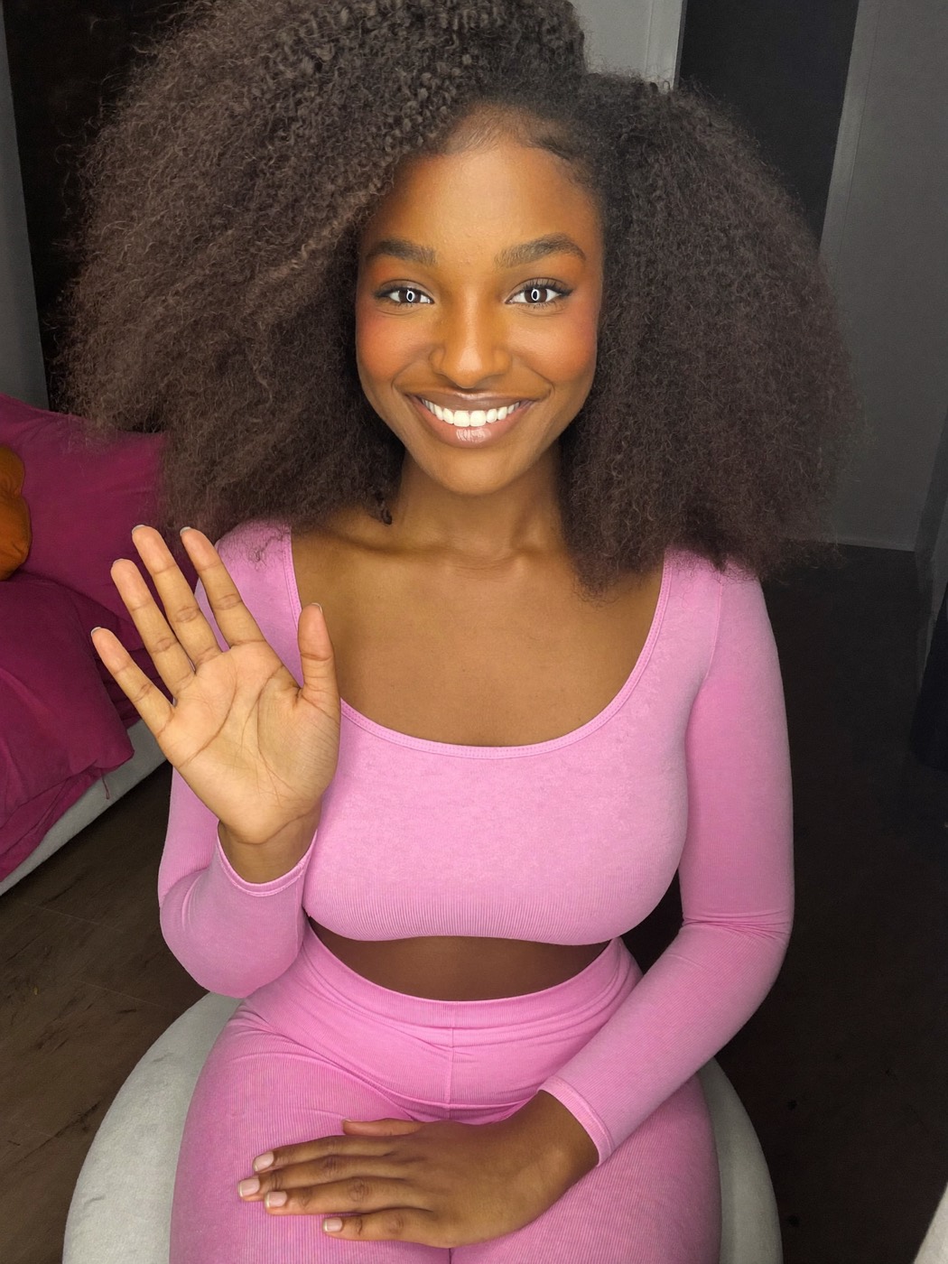 Creator smiling warmly at her camera