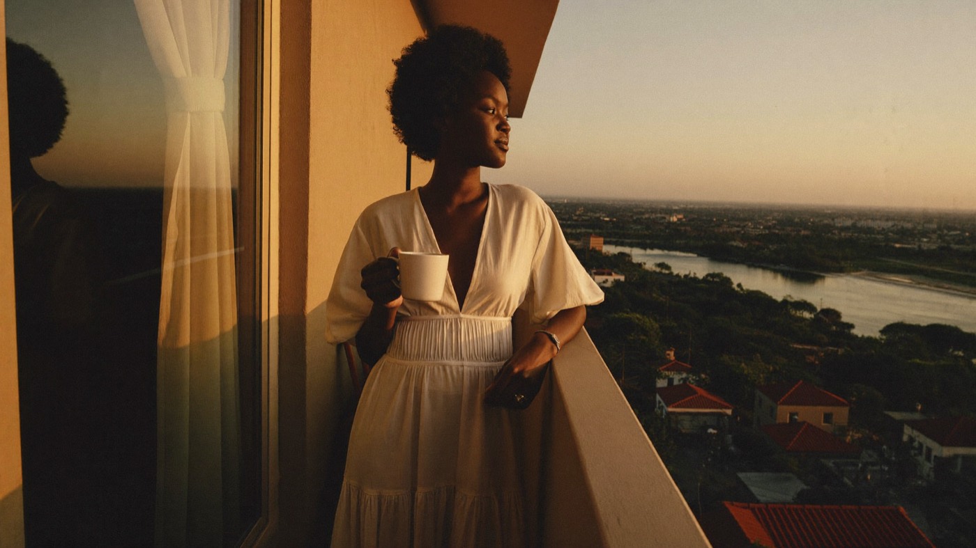 Creator relaxing on a balcony at sunset