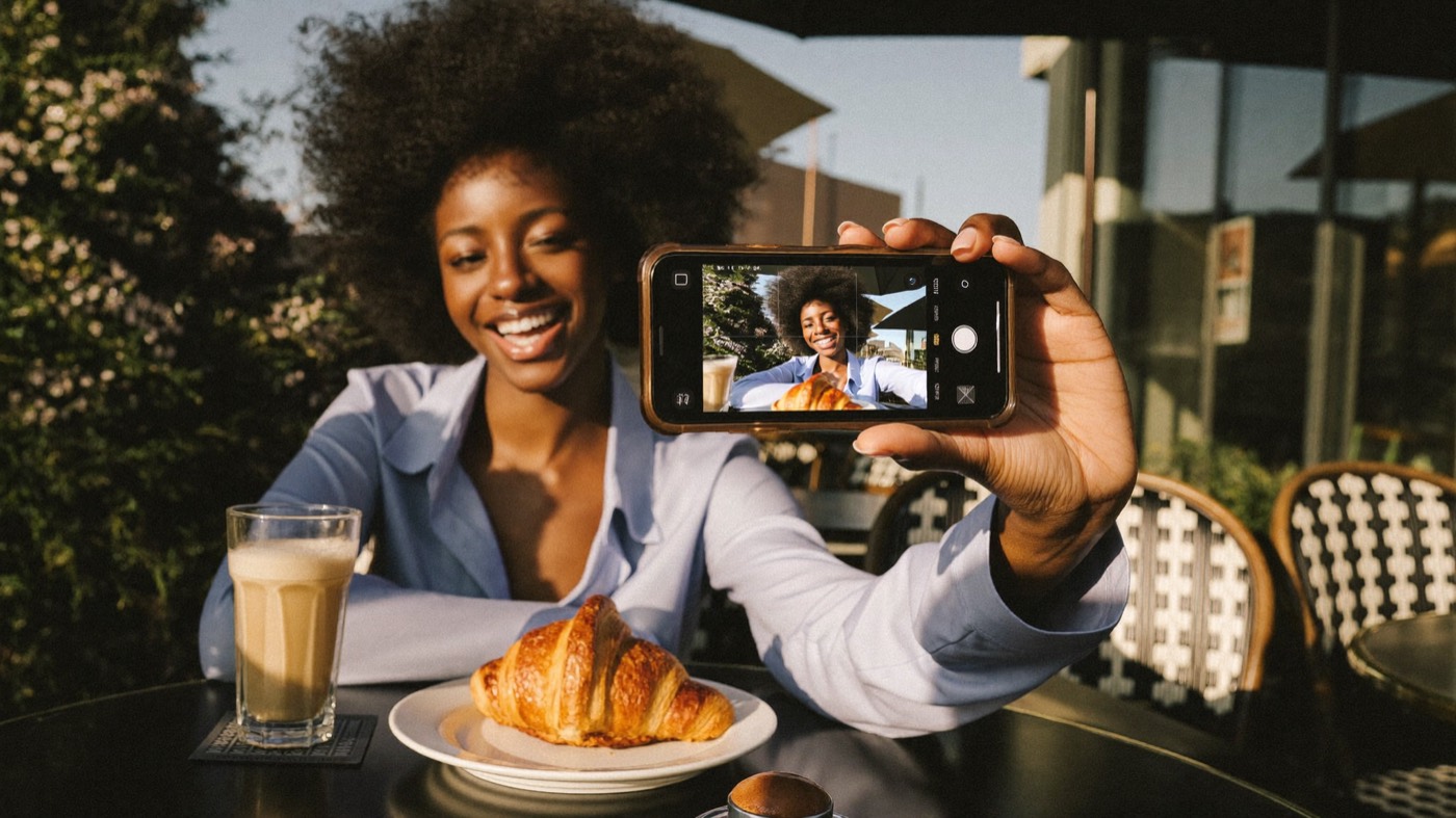 Creator filming a clip at a cafe